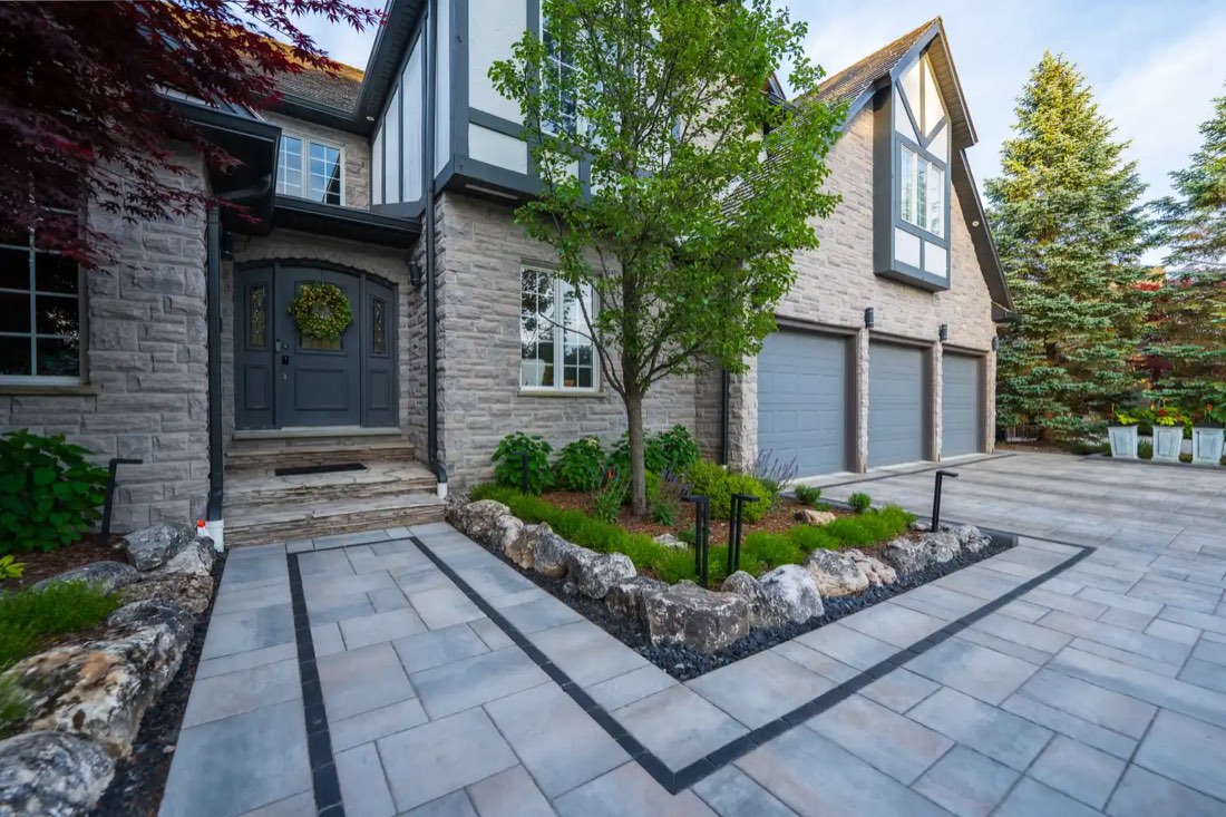 Paver entry court with planting beds and path lighting