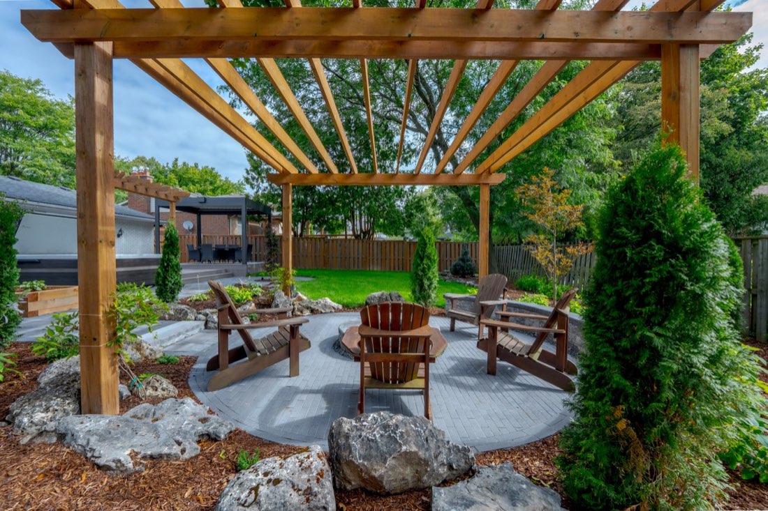 Cedar pergola and fire pit at dusk