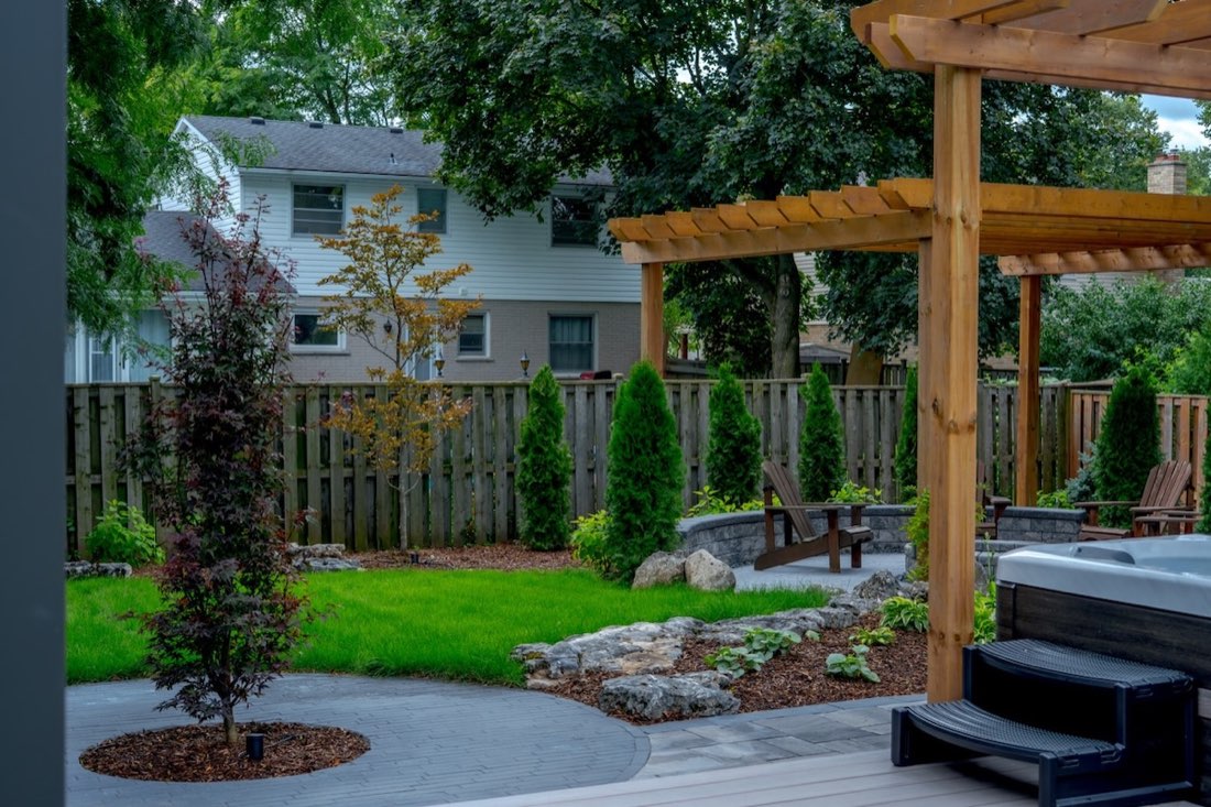 Lawn, privacy cedars and pergola viewed from the deck