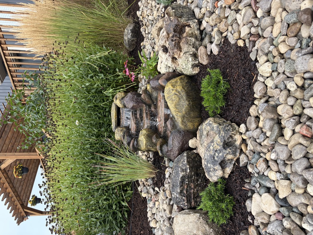 Water bubbling over natural stones in a river-rock bed